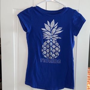 A blue pineapple t-shirt
